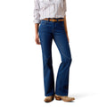 Woman wearing dark blue slim trouser leg jeans and a patterned shirt