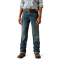 Person wearing blue Ariat jeans and a plaid shirt.
