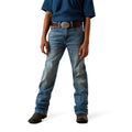 Person wearing blue boot cut Ariat jeans and a dark shirt 