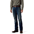 Cowboy wearing blue Ariat straight leg jeans and a green shirt on a white background