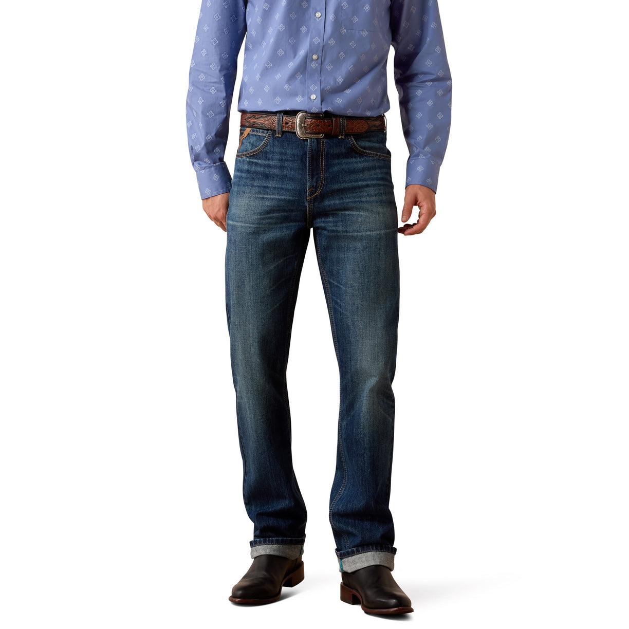 Cowboy wearing a blue patterned shirt, dark blue jeans, and brown shoes.