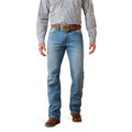 Cowboy wearing blue Ariat boot cut jeans with a checkered shirt and brown belt on a white background