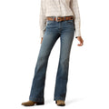 Model wearing Ariat blue slim trouser leg jeans and a patterned shirt on a white background