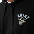 Black hoodie with Ariat logo featuring a bull skull design on a beige background