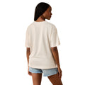 Woman wearing a white t-shirt and denim shorts on a white background