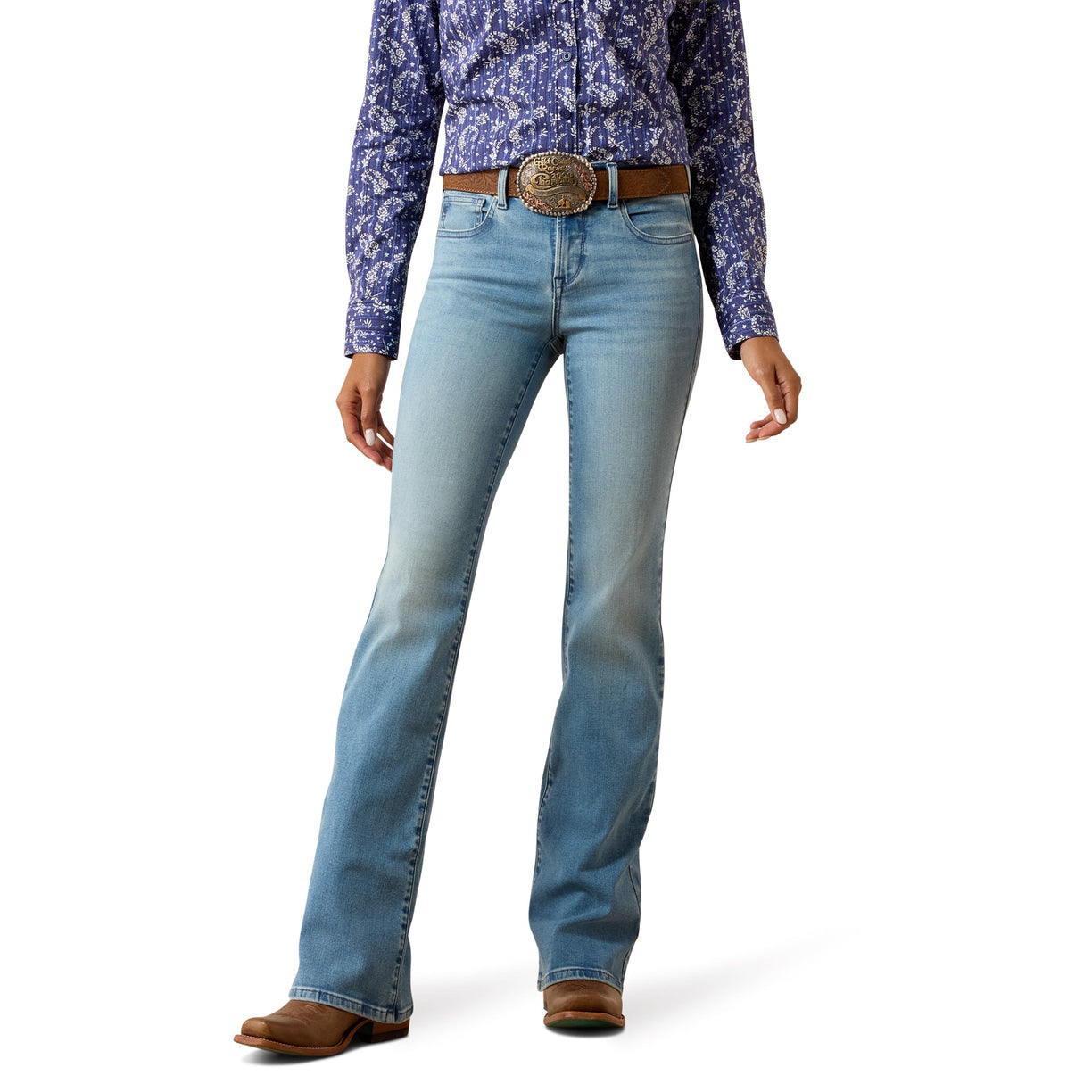 Woman wearing blue western jeans and a patterned shirt on a white background