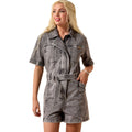 Woman wearing a grey Ariat denim dress with a belt on a white background