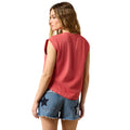 Woman wearing a red sleeveless top and denim shorts with star patterns on a white background