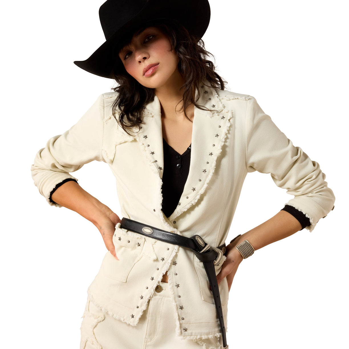 Woman wearing a white jacket with black trim, black hat, and black belt on a white background
