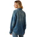 Woman wearing a blue denim shirt on a white background
