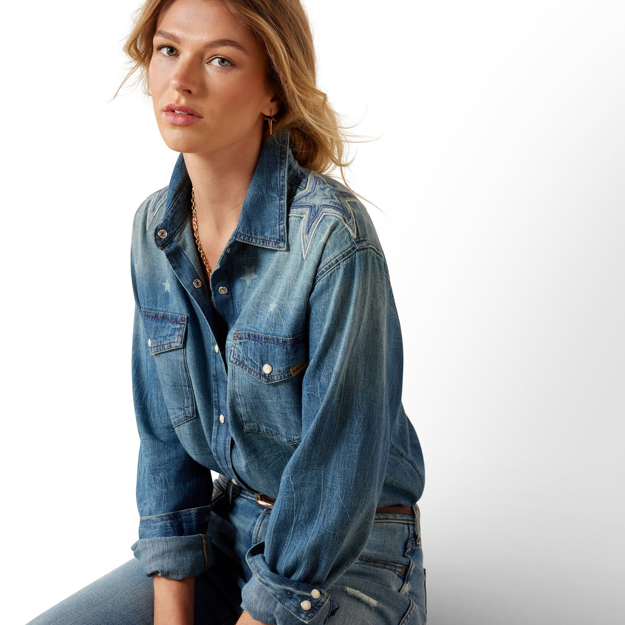 Woman wearing a denim jacket on a white background