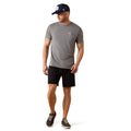 Man wearing a gray t-shirt, black shorts, and a navy cap on a white background