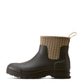 Dark rubber boot with houndstooth patterned cuff on a white background