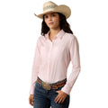 Cowgirl wearing light pink western Everything Shirt by Ariat, with western hat, jeans and belt.
