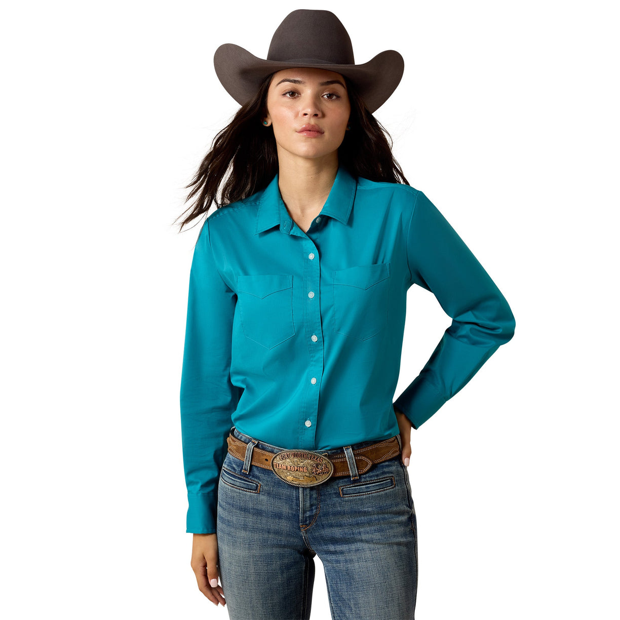 Women wearing teal blue solid coloured western long sleeved button up shirt, with jeans and black cowboy hat.