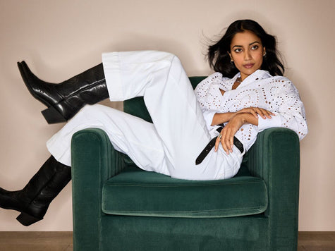 Woman wearing Ariat Countryside clothing and black leather boots.
