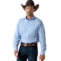 Man wearing a light blue shirt, dark jeans, and a brown cowboy hat on a white background