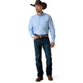 Man wearing a light blue shirt, dark jeans, and a cowboy hat on a white background