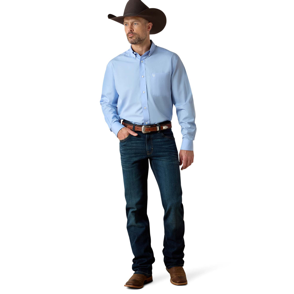 Man wearing a light blue shirt, dark jeans, and a cowboy hat on a white background