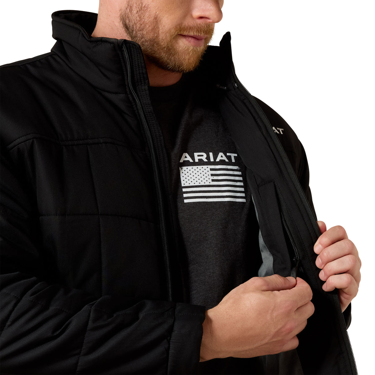 Person wearing a black Ariat jacket with a logo on a white background