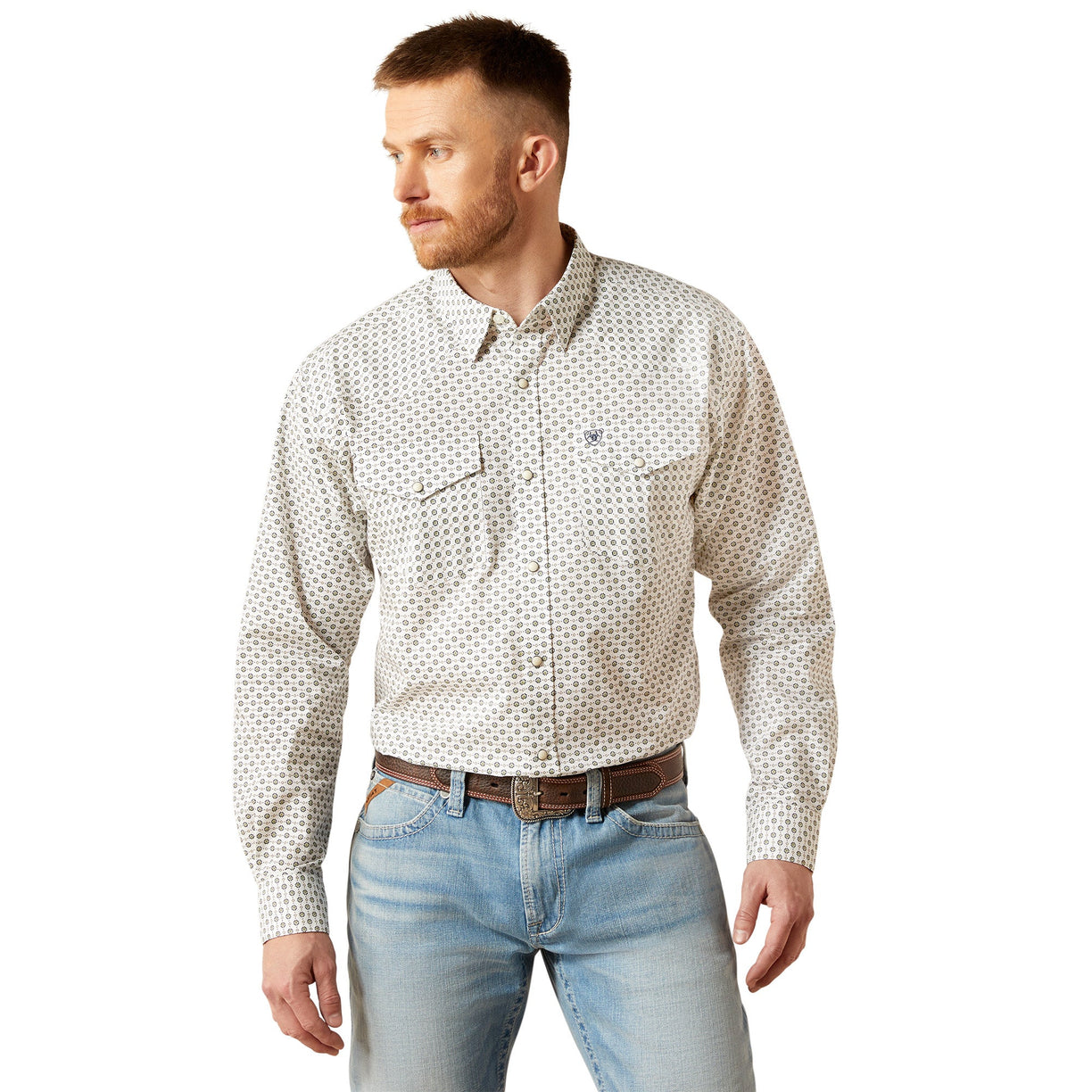 Man wearing a patterned shirt and jeans on a white background