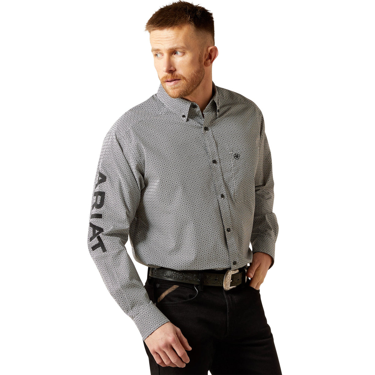 Man wearing a gray patterned shirt with 'Ariat' branding on a white background