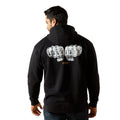 Person wearing a black hoodie with text on the back against a white background