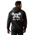 Person wearing a black hoodie with Ariat logo on the back