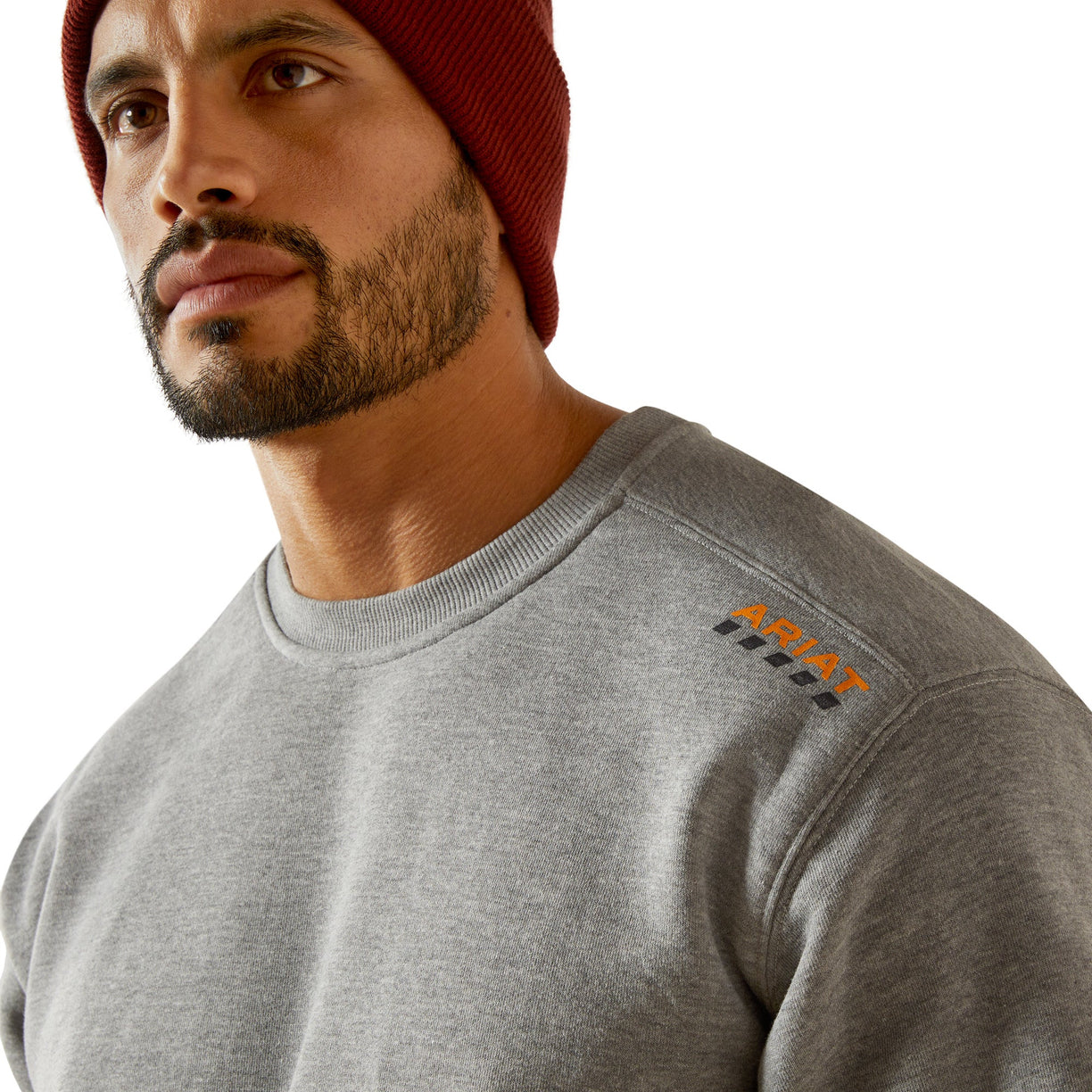 Man wearing a gray sweatshirt with a brand logo on a white background