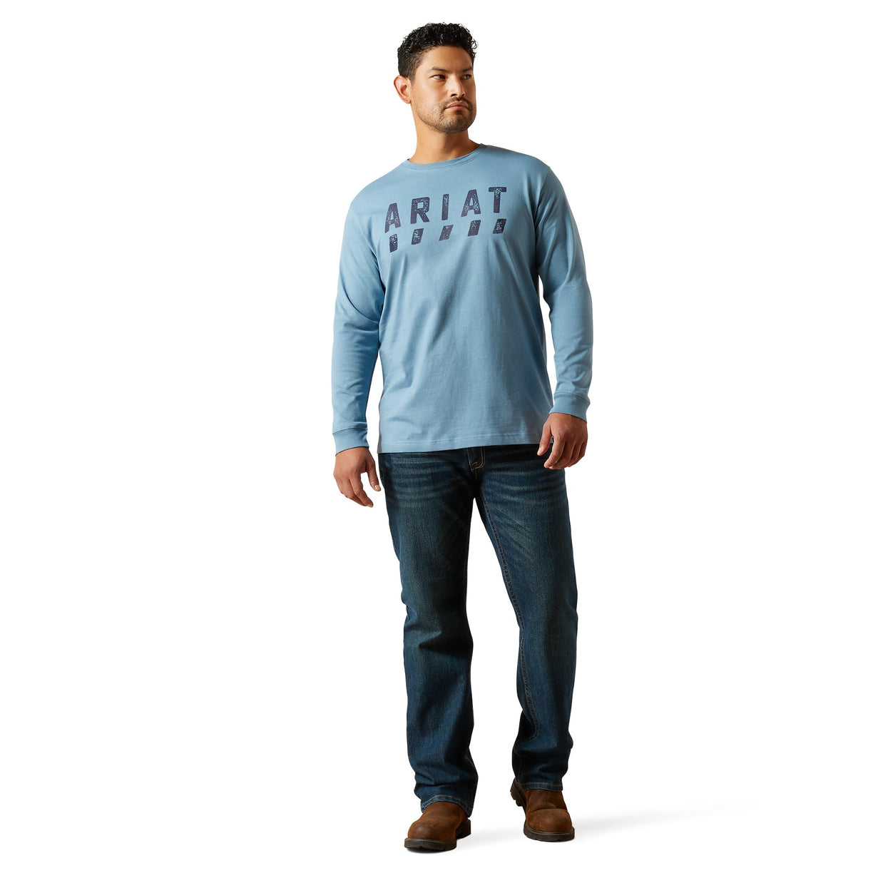 Man wearing a light blue long-sleeve shirt with 'Ariat' branding on a white background