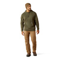 Man wearing a green hoodie and brown pants on a white background