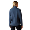 Woman wearing a blue jacket on a white background