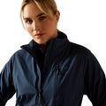Woman wearing a navy blue jacket on a white background