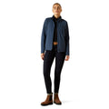 Person wearing a blue jacket, black pants, and brown boots on a white background