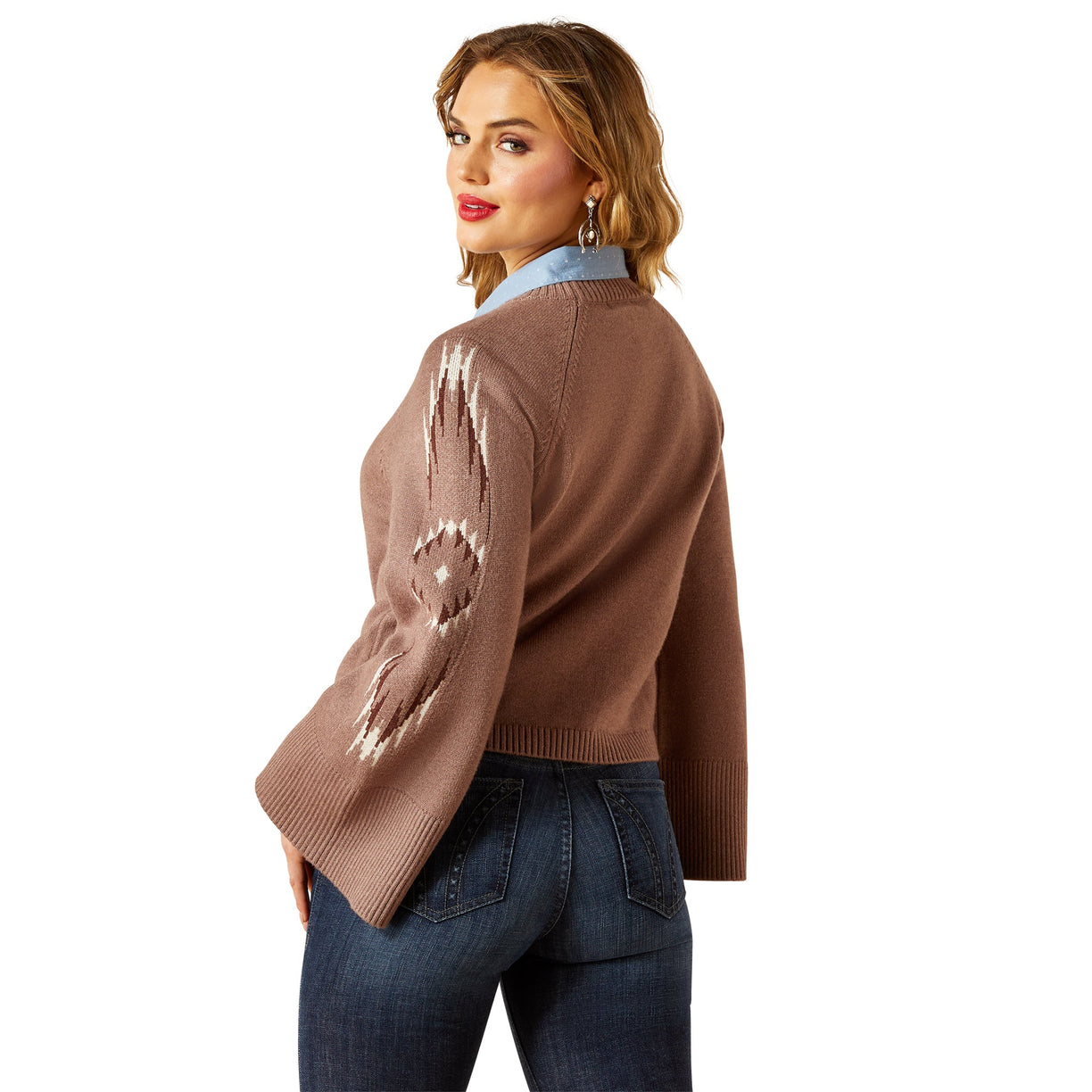 Woman wearing a brown sweater with sequin details on a white background