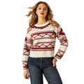 Woman wearing a patterned sweater and jeans on a white background