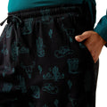 Black shorts with teal western pattern worn by a person