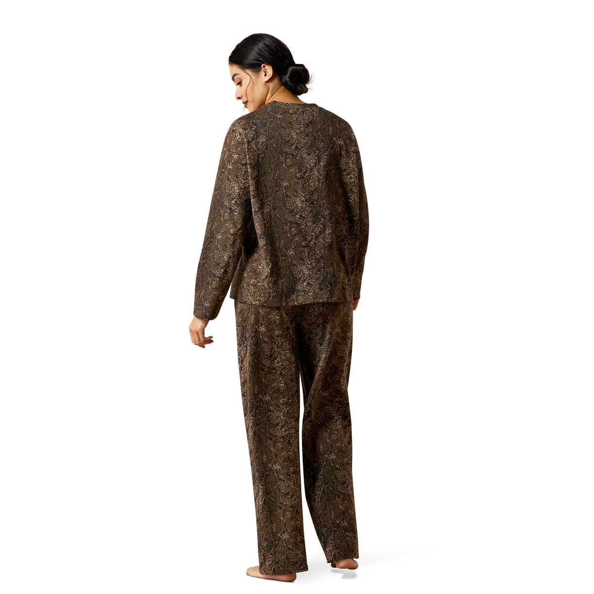 Woman wearing a brown patterned outfit on a white background