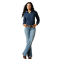 Woman wearing a blue plaid shirt and light blue jeans on a white background