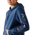 Person wearing a blue hoodie with 'Repair' branding on a white background