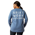Person wearing a blue long-sleeve shirt with 'Ariat Work Estd. 1993' text on the back.