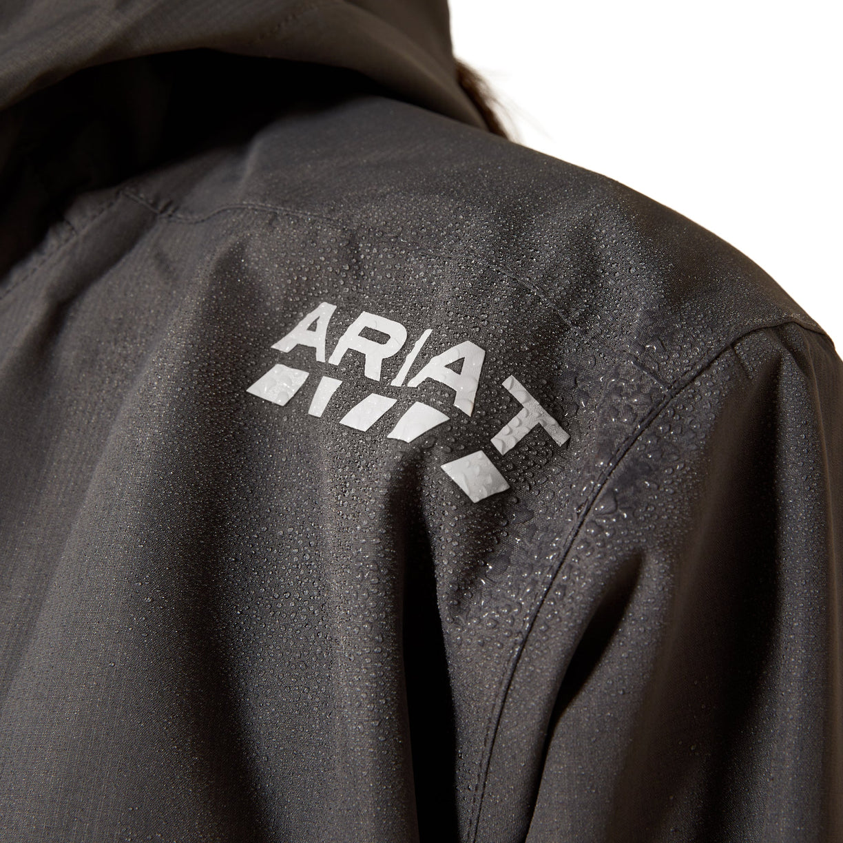Close-up of a black jacket with 'Ariat' logo on the back