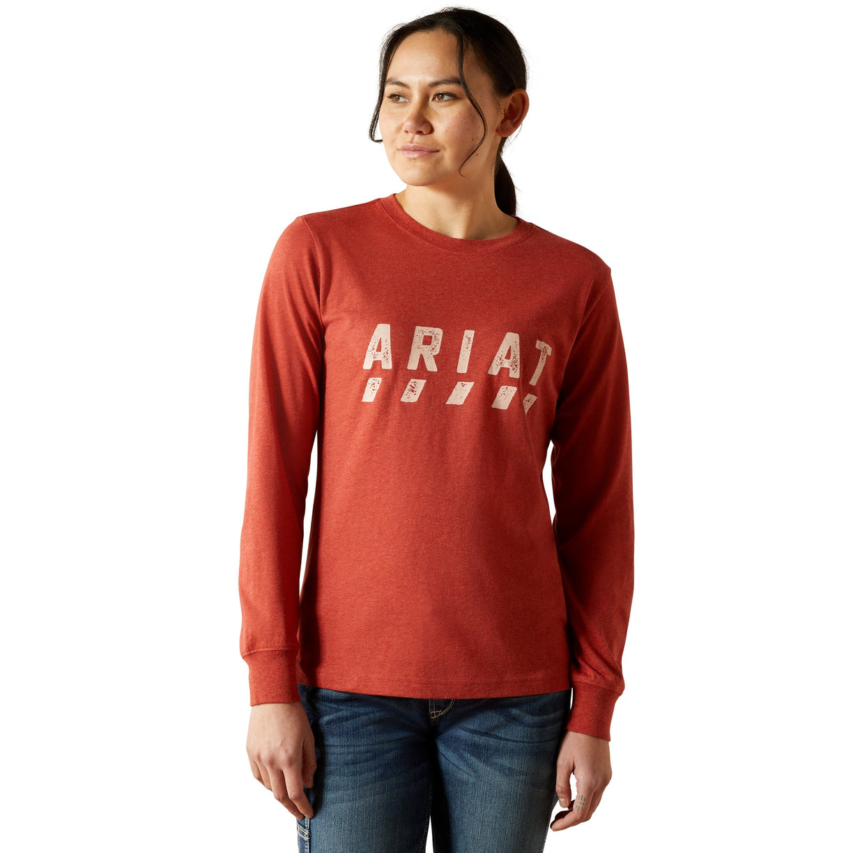 Person wearing a red long-sleeve shirt with 'Ariat' logo on a white background