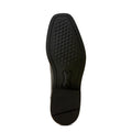 Black shoe sole with green tread pattern on a light gray background