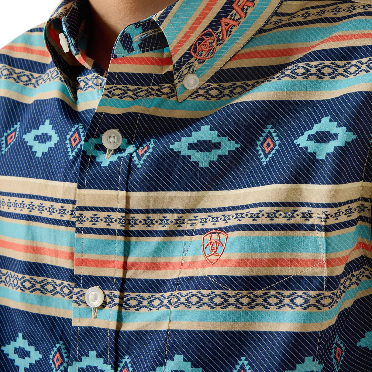 Close-up of a patterned shirt with visible brand logo