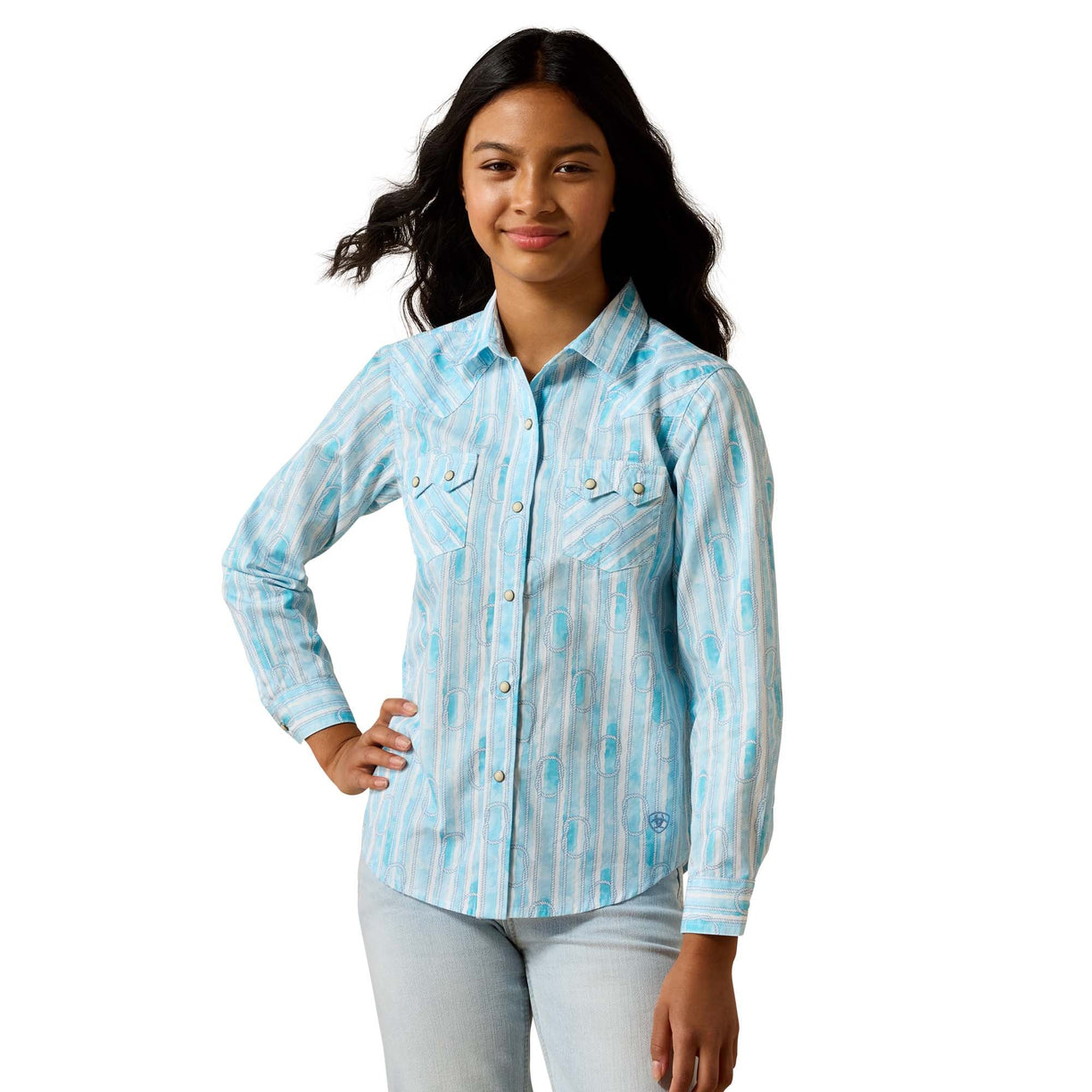 A woman modeling a light blue and white vertically striped long-sleeve button-up shirt with two chest pockets, paired with light-wash jeans, against a plain white background.