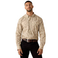 A man wearing a beige and brown paisley patterned long-sleeve western shirt with black pants, standing against a plain white background.