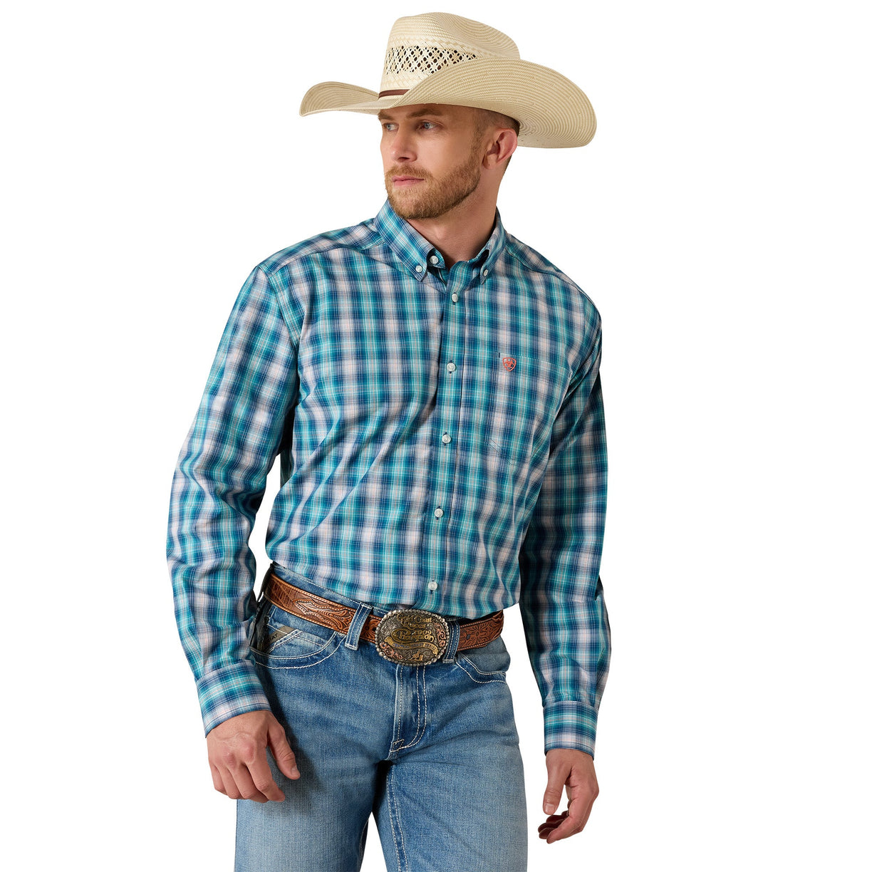 A man wearing a turquoise and blue plaid western long-sleeve button-down shirt, blue jeans, a brown leather belt with a large silver buckle, and a beige cowboy hat, photographed against a solid white background.