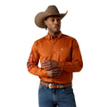 Man wearing an orange shirt, blue jeans, and a brown cowboy hat on a white background