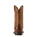 Brown cowboy boot with intricate embossing on a white background